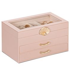 a pink jewelry box with two drawers and gold handles on the bottom, filled with rings