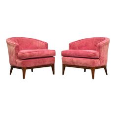 a pair of pink chairs sitting next to each other