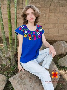 Beautiful blouse made by hand in Chiapas, Mexico creating fashion and art. This is a blouse blue with beautiful colorful flowers and short sleeve. Very comfortable, Goes great with jeans, leggings, skirt, shorts... SIZES This blouse is one size, it can fit small and medium sizes Each piece is unique and handmade with dedication and taking care of every detail achieving the best quality in our products, which is why it makes it beautiful and unique each of the embroidered flowers. 1 piece per ord Mexican Shirt, Mexican Shirts, Mexican Outfit, Stitch Flowers, Skirt Shorts, Jeans Leggings, Handmade Flower, Flower Shirt, Cross Stitch Flowers