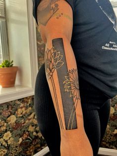 a woman with a flower tattoo on her arm