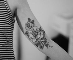 a woman with a flower tattoo on her arm