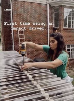 a woman is using an impact driver on a large piece of metal with the words, first time using an impact driver