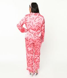 Snuggle up in sweet dreams! Made from smooth pink satin and adorned with delightful candy cane prints throughout, these pajamas will transport you to a cozy winter wonderland. The top features long sleeves, a classic collar neckline, a convenient button-up front, and even handy pockets for that midnight snack stash. The bottoms boast an elastic band for the perfect fit and come complete with a self-tie for added comfort. Whether you're lounging around the house or indulging in some well-deserved beauty sleep, this adorable set will definitely make bedtime stylishly merry!Available in sizes S-XL while supplies last. Snack Stash, Pink Candy Cane, Satin Pajama Set, Midnight Snack, Satin Pajama, Beauty Sleep, Holiday Tops, Satin Pyjama Set, Satin Pajamas