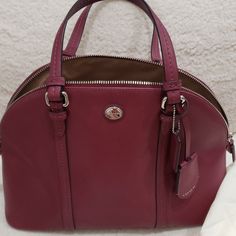 Never Wore Brand New But No Tags Burgundy Color Coach Handheld Bag With Zipper Closure, Handheld Coach Bags With Zipper Closure, Burgundy Top Handle Bag With Zipper Closure, Burgundy Top Handle Bag With Zipper, Chic Burgundy Coach Bag, Classic Burgundy Bags For Errands, Coach Burgundy Bag With Zipper Closure, Coach Burgundy Bag With Adjustable Strap, Coach Burgundy Satchel Shoulder Bag