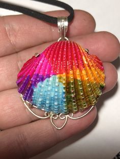 Rainbow Shell Pendant. This is a silver plated natural seashell that has been dyed. Handmade Silver Shell Pendant, Handmade Silver Pendant Shell, Handmade Shell Pendant In Ocean-inspired Style, Silver Shell Necklace For Summer Gift, Silver Shell Pendant For Beach, Handmade Silver Shell For Beach, Silver Beach Pendant Shell, Unique Handmade Shell Jewelry, Handmade Silver Shell Necklace