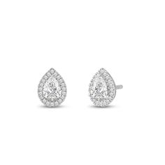 a pair of diamond earrings on a white background