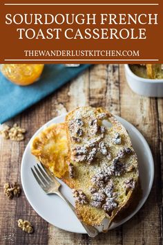 french toast casserole on a white plate with a fork and oranges in the background