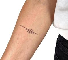 a woman's arm with a small line tattoo on the left side of her arm