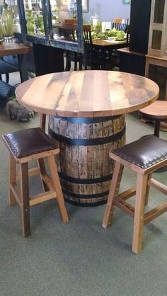 a wooden barrel table with stools around it