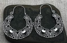 Silver cut out filigree hoop earrings. They are eye catching and versatile. Dress them up or down. Perfect for everyday wear. The hoops measure about 2" long by 1 5/8" wide. Made from plated silver. Thanks for stopping by! Please take a moment and visit the rest of my Etsy shop. I have many more unique jewelry designs to choose from! Tiger Flower Jewelry Bohemian White Pierced Hoop Earrings, White Bohemian Pierced Hoop Earrings, Bohemian Hypoallergenic Earrings For Festivals, White Teardrop Bohemian Hoop Earrings, Bohemian White Teardrop Hoop Earrings, Bohemian Filigree Hoop Earrings For Festival, Bohemian Hypoallergenic Hoop Earrings For Festivals, White Hoop Earrings For Festival, Festival Teardrop Hoop Earrings