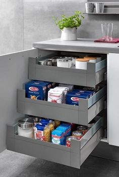 an open drawer in a kitchen next to a counter