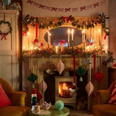 a living room filled with furniture and a fire place covered in christmas decorations next to a fireplace