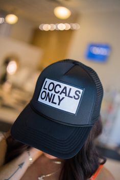 Locals Only! Black trucker hat with adjustable back. Comfortable and adjustable-one size fits all. The trucker hat style is so on-trend and super flattering. This hat is the perfect accessory for your next girl's trip! -100% polyester foam front, 100% nylon mesh back. -Adjustable snapback. Trendy Mesh Trucker Hat With Adjustable Fit, Trendy Adjustable Mesh Trucker Hat, Trendy Mesh Snapback Hat, Trendy Trucker Hat, 5-panel, One Size, Trendy Mesh Snapback Hat With Curved Bill, Trendy Mesh Trucker Hat For Streetwear, Adjustable Mesh Hat With Letter Print, Trendy Mesh Snapback Trucker Hat, Adjustable Summer Trucker Hat One Size