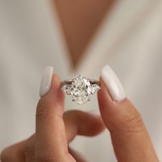 a close up of a person holding a diamond