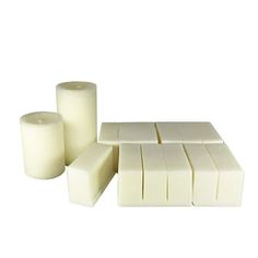 white candles and blocks of wax on a white background