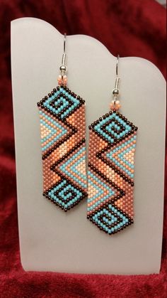 two pairs of beaded earrings on display