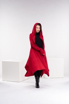 "This asymmetrical and modern cloak with hood has two side pockets, a super comfy hood, and thumb holes for a fabulous look. If you want to add a belt to the cloak, please add this listing to your order, and choose from the options: https://www.etsy.com/listing/1309043791/customization-add-a-belt-to-the-cloak?ref=listings_manager_grid The model in the picture is 170cm. ⅼ 5.7 ft. tall and is wearing size XS/color: red 🌟 INFO: * Worldwide EXPRESS shipping - please provide a phone number for shipp Cloak With Hood, Cyberpunk Cosplay, Red Cloak, Long Sweater Coat, Wide Leather Belt, Wool Cape, Hooded Cloak, Designer Drapes, Long Sweater