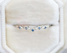 a white gold ring with blue sapphire stones