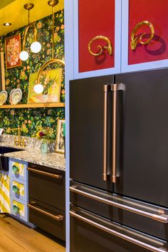 a black refrigerator freezer sitting inside of a kitchen next to a counter top oven