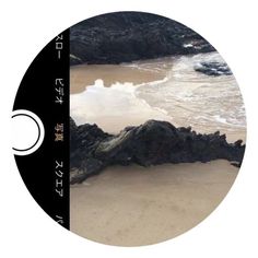 an aerial view of the beach and ocean with rocks in the foreground, taken from above