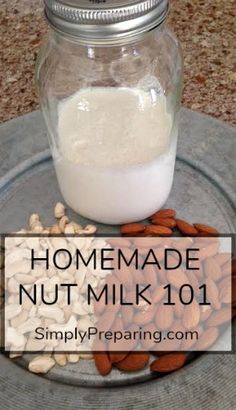 homemade nut milk in a glass jar and almonds on a plate