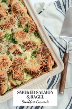 a casserole dish with shrimp and broccoli in it on a striped towel