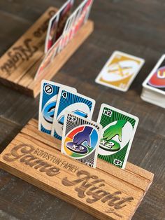 four playing cards are sitting on a wooden stand