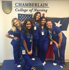 some pretty young ladies in scrubs posing for a photo