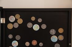 a black frame with lots of different coins on it