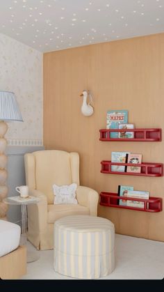 a living room filled with furniture and a lamp on top of a wooden shelf next to a chair