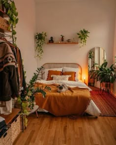 a bed sitting in a bedroom next to a mirror and potted plant on a shelf