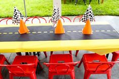 the table is set up with red chairs and orange cones