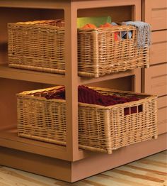 two wicker baskets are stacked on top of each other in front of a cabinet