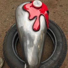 a close up of a motorcycle tire with red paint on the top and bottom part