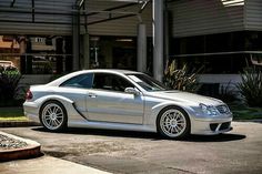 a silver car parked in front of a building