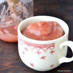 two cups filled with food sitting next to each other on top of a wooden table