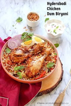 a bowl filled with chicken and rice on top of a table