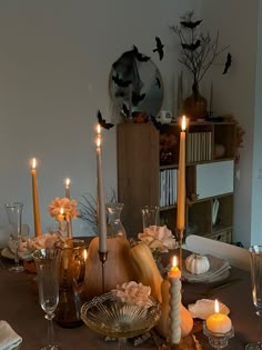 a dining room table is set with candles and dishes for thanksgiving dinner guests to enjoy