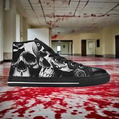 a pair of shoes with skulls painted on them sitting in a hallway covered in blood