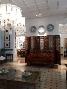 a living room filled with furniture and chandelier