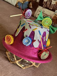 a colorful hat with lollipops and candy on it