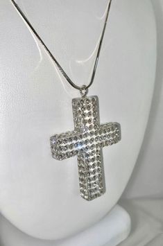 This absolutely stunning one of a kind necklace is handcrafted on a transparent 3D cross shaped acrylic setting, while embellished with Swarovski crystal elements. Comes included with an Italian made, 18 inch, 925 sterling silver chain.  The quality in craftsmanship that went into creating this exquisite piece really showcases itself as art on your neck. The necklace is lightweight, comfortable to wear, and is perfect for styling up with any look. This necklace sparkles and looks even more beautiful in person, especially in the natural sunlight.  Comes included with an 18 inch, 925 sterling silver chain.  Arrives beautifully packaged in a luxury gift box and comes included with a polishing cloth. Makes an excellent gift idea too.  💎MORE DETAILS 💎 * Material: Acrylic (transparent/clear), Crystal Cross Pendant Jewelry With Rhinestones, Crystal Rhinestone Cross Pendant Jewelry, Crystal Cross Pendant With Rhinestones, Spiritual Crystal Necklace In Clear Color, Clear Crystal Spiritual Necklace, Crystal Cross Jewelry With Rhinestones, Crystal Rhinestone Cross Jewelry, White Crystal Cross Necklaces, White Cross Necklace For Party