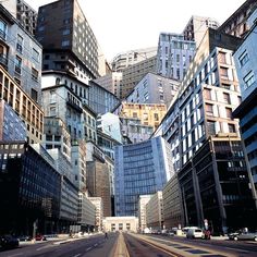 an empty city street lined with tall buildings