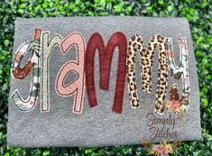 a gray t - shirt with the word mama written in leopard and letters on it