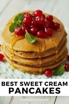 stack of pancakes topped with fresh cranberries and mint leaves