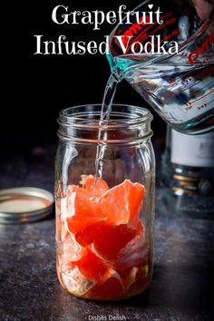 grapefruit infused vodka being poured into a jar