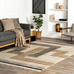 a living room with a couch, chair and rug