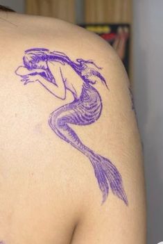 a woman with a purple tattoo on her back