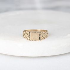 This ring features a rectangle, brushed gold center signet (perfect for engraving) with a diamond cut rectangle outer layer and yellow gold band with diamond-cut stripes on the shoulders. Perfect for everyday wear, this ring would make a great customizable gift for any occasion! Metals: 10k yellow gold rectangle center signet (approx. 6 x 5 mm)  10k yellow gold band 1.7 - 1.85 g Please allow up to 5 business days for processing. Currently only shipping within Canada and the US. | c u r a t e d | Visit our website for curated and modern pieces  https://www.menkduke.com | f a c e b o o k | Follow us on Facebook for new item announcements and discounts  https://www.facebook.com/menkDUKE/ | i n s t a g r a m | Follow us on instagram to see what we're up to @menkDUKE Modern Gold Rectangular Engraved Ring, Yellow Gold Rectangular Engraved Promise Ring, Modern 14k Gold Rectangular Engraved Ring, Modern 14k Gold Engraved Rectangular Ring, Yellow Gold Engraved Rectangular Ring, Engraved Rectangular Yellow Gold Promise Ring, Rectangular Yellow Gold Engraved Promise Ring, Gold Minimalist Engraved Rectangular Ring, Minimalist Gold Engraved Rectangular Ring