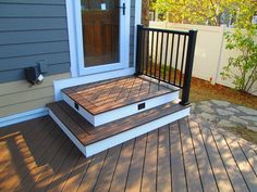 a wooden deck with steps leading up to the door